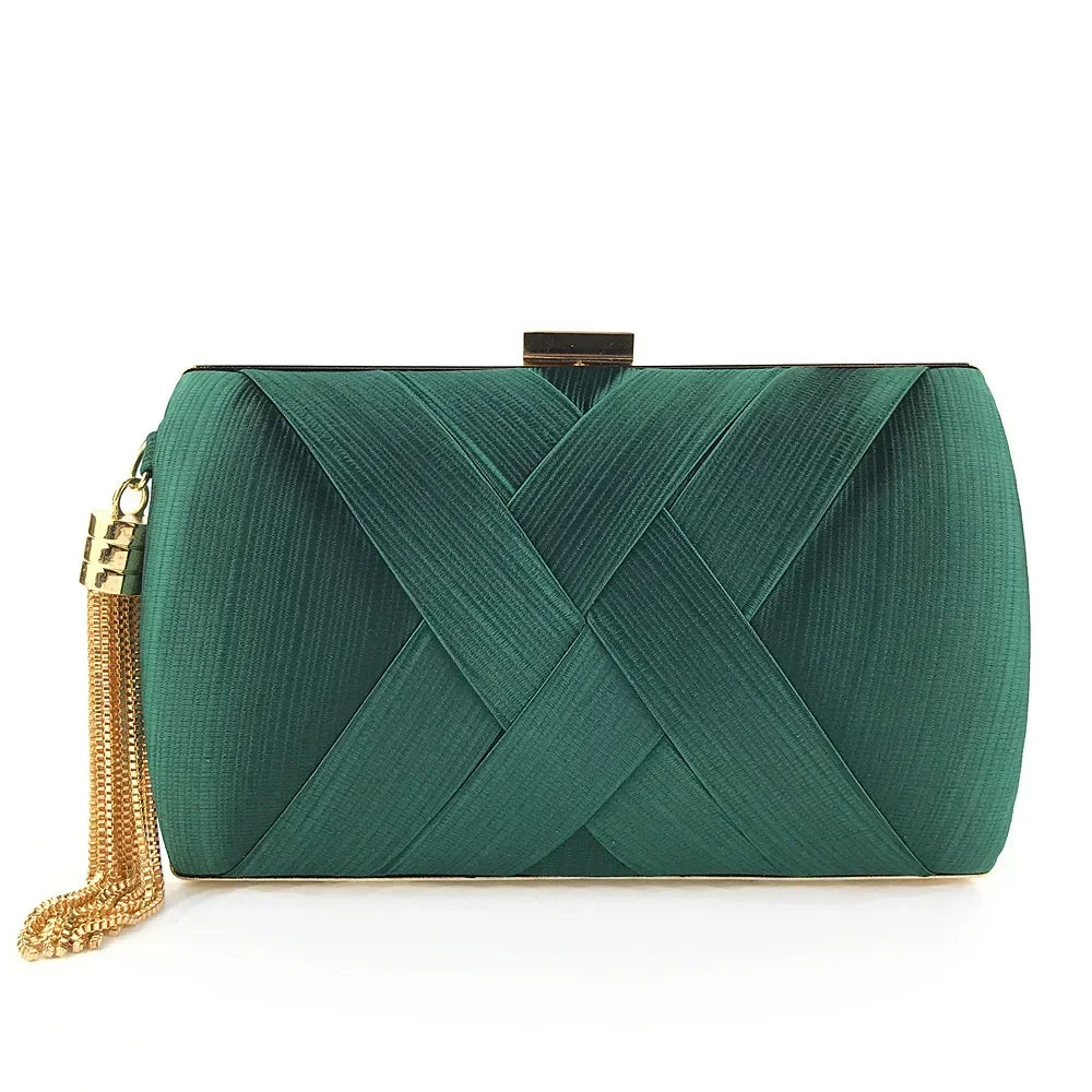 Green clutch bag with gold tassel on a white background