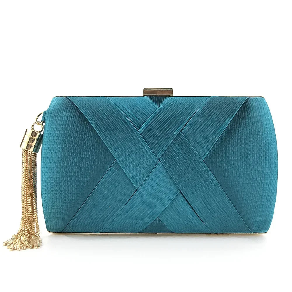 Teal clutch bag with gold tassel on a white background