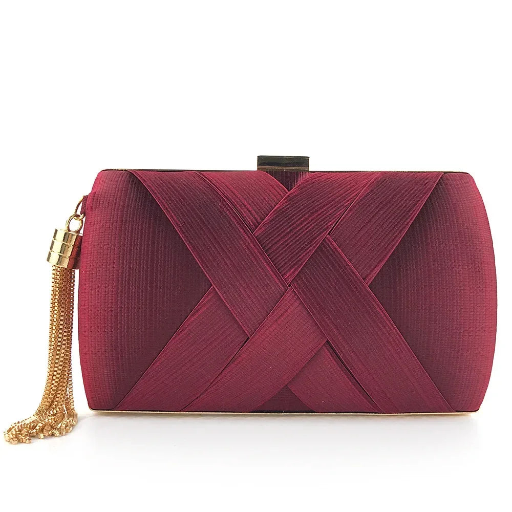 Maroon clutch bag with gold chain on a white background