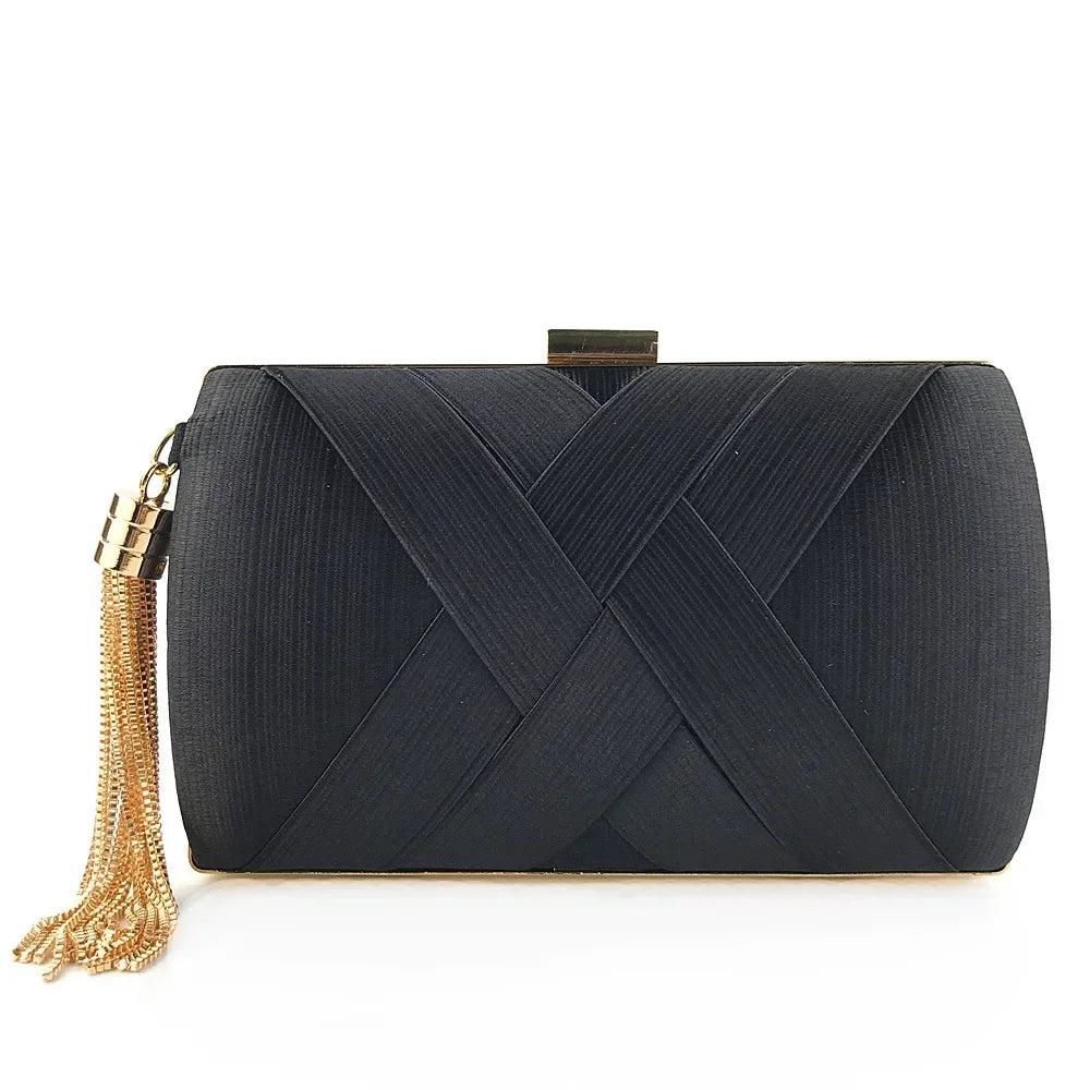 Black clutch bag with gold tassel on a white background
