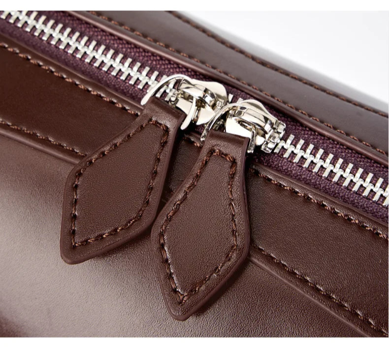 Close-up of a brown leather bag with a zipper, highlighting texture and design details.
