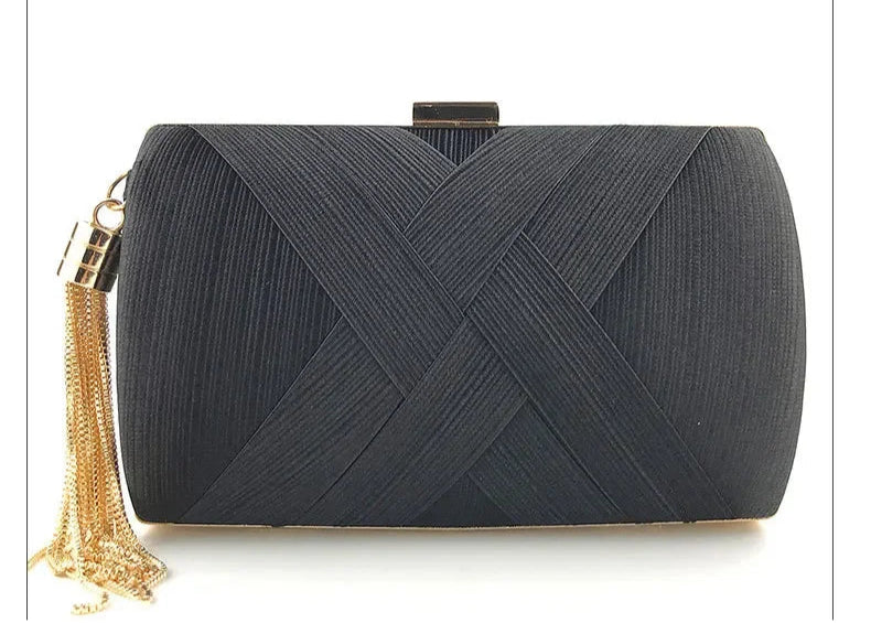 Black clutch bag with gold tassel on a white background