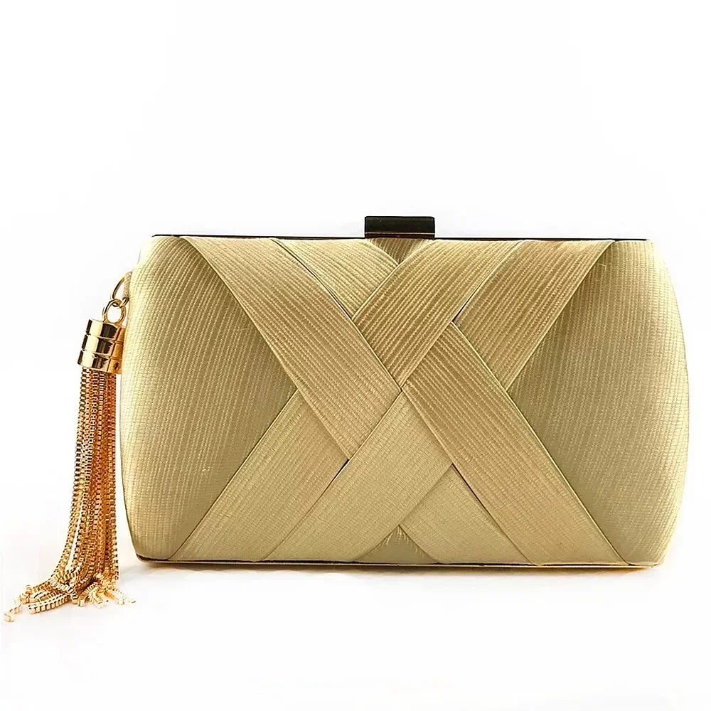 Gold clutch bag with a tassel on a white background