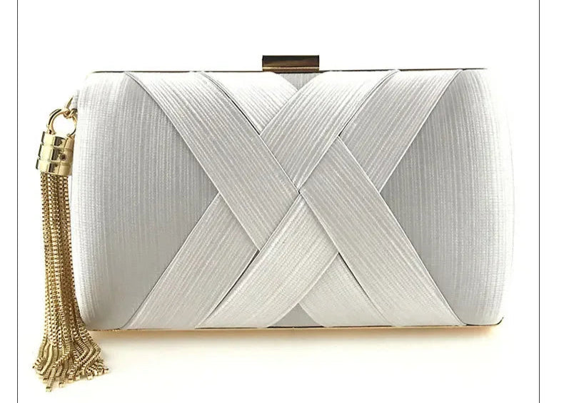 White clutch bag with gold tassel on a white background