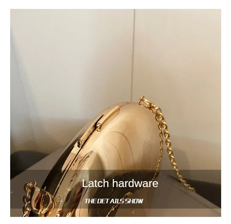 VaultHaus Acrylic Shell Shape Clutch Bag with gold chain and latch hardware detail