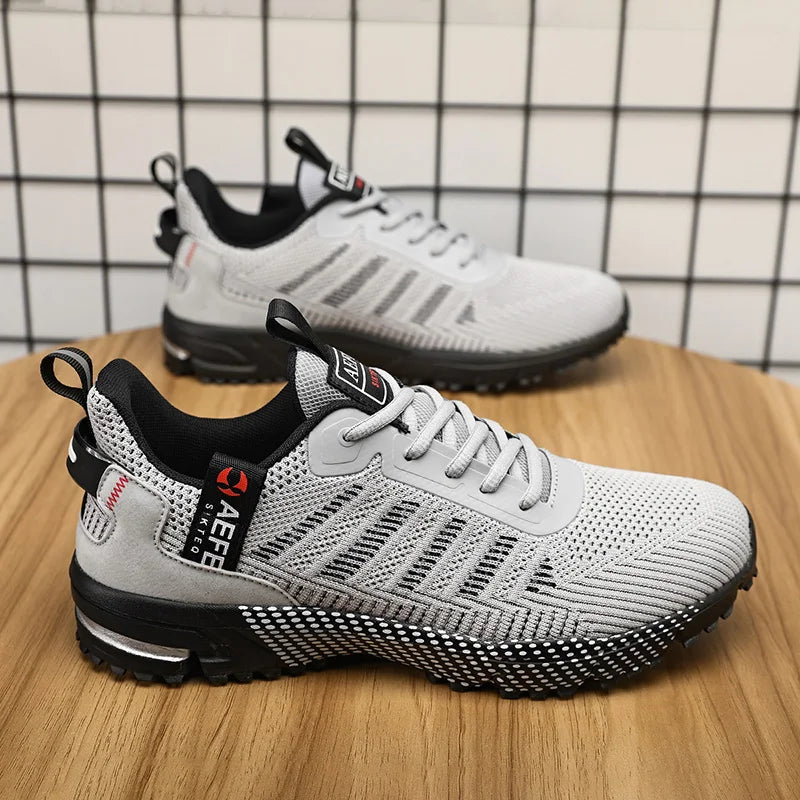 VaultHaus gray lightweight athletic sneakers for men with breathable mesh and black sole on wooden surface