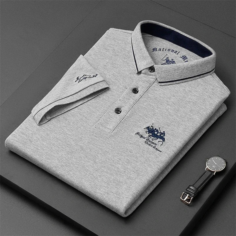 Gray VaultHaus comfortable men's polo top neatly folded with a watch on the side