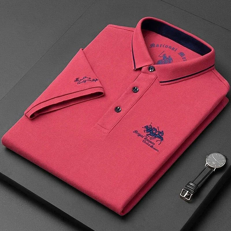 Stylish red comfortable men's polo top folded neatly with a watch on a dark surface