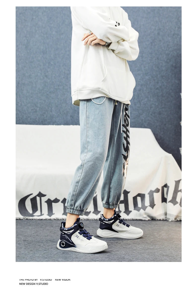 VaultHaus comfortable non slip lace up men's sneakers in white and navy worn with casual jogger pants