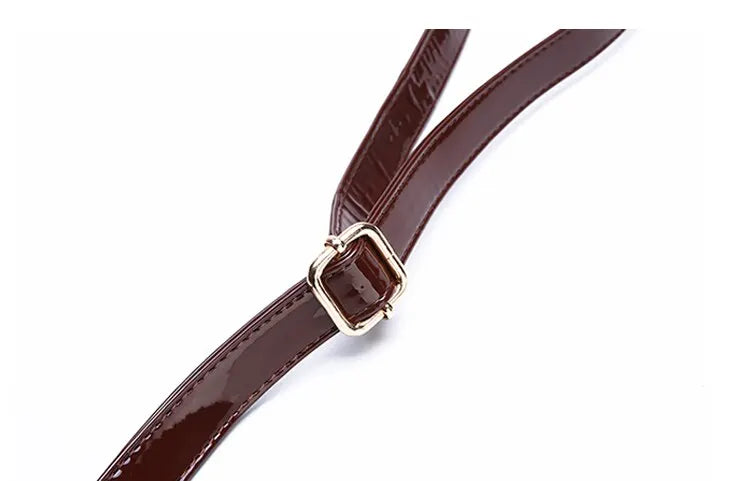 Close-up of adjustable strap detail on crocodile print tote bag by VaultHaus with shiny finish