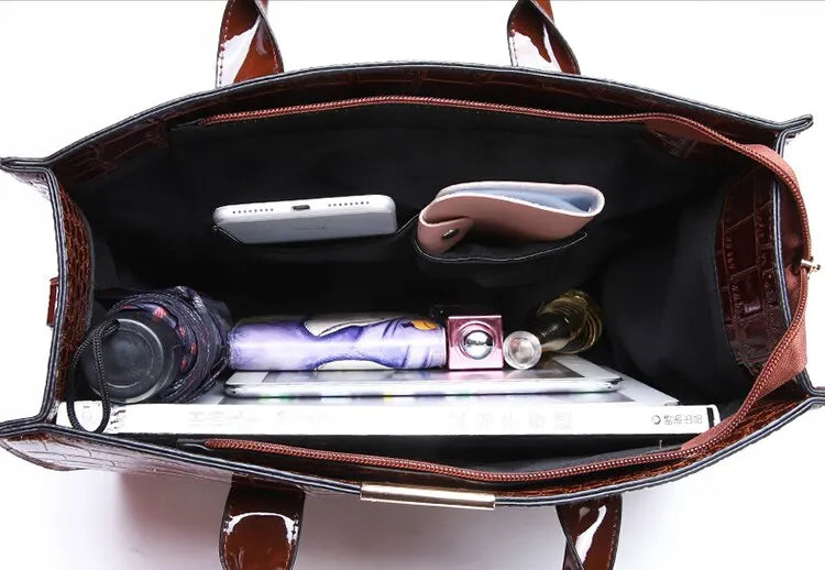 Interior view of a crocodile print tote bag featuring multiple compartments for organization