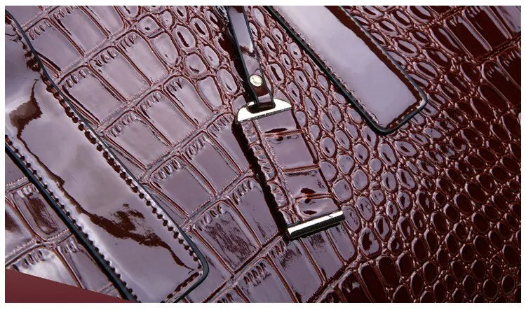 Elegant burgundy crocodile print tote bag with a glossy finish and stylish hardware details
