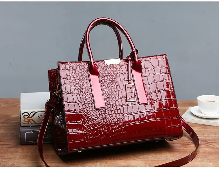 Stylish red crocodile print tote bag with double handles and shoulder strap for versatile use