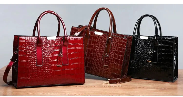 Stylish crocodile print tote bag trio in red, brown, and black with sleek handles