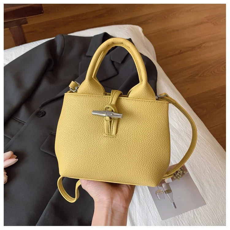 VaultHaus designer women's leather shoulder bag in mustard yellow with top handles and detachable strap