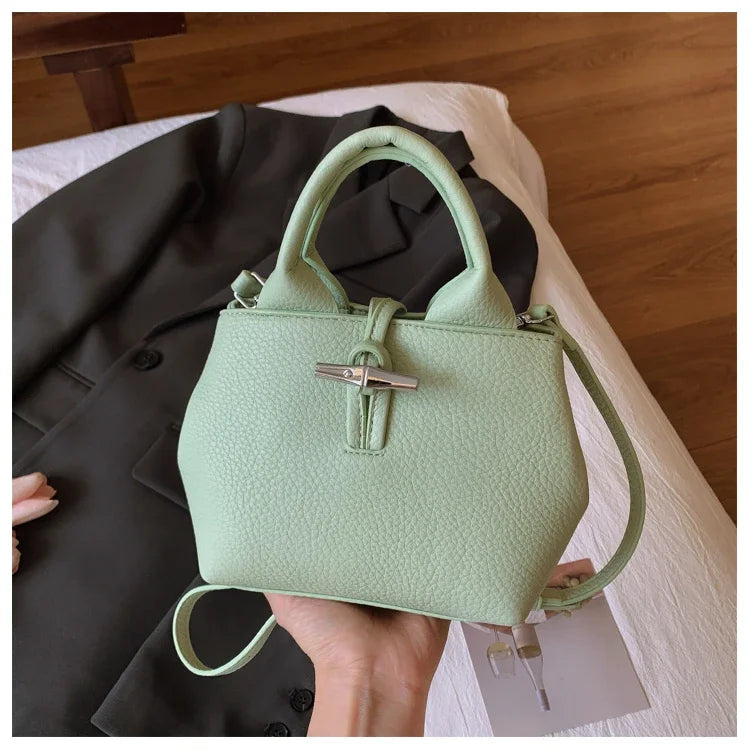 VaultHaus designer women's leather shoulder bag in light green with textured finish and silver clasp