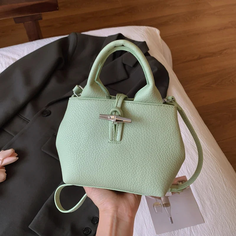 VaultHaus designer women's leather shoulder bag in light green with silver clasp and detachable strap