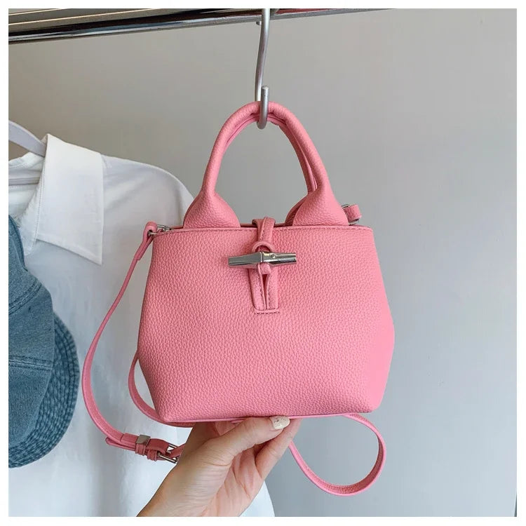 VaultHaus designer women's leather shoulder bag in pink with top handles and adjustable strap