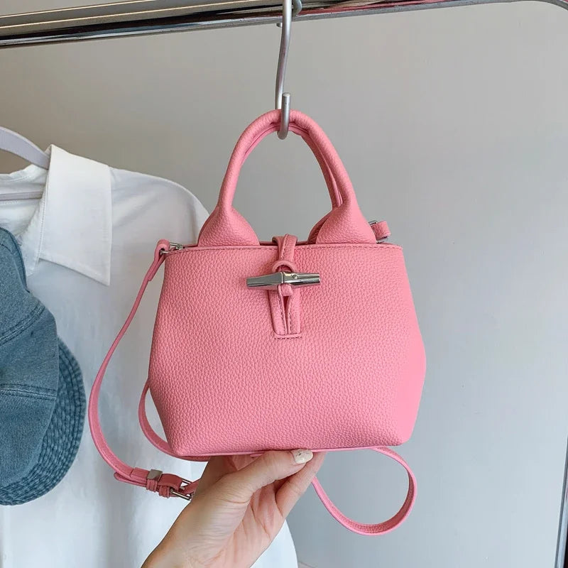 VaultHaus designer women's leather shoulder bag in pink with silver buckle and adjustable strap