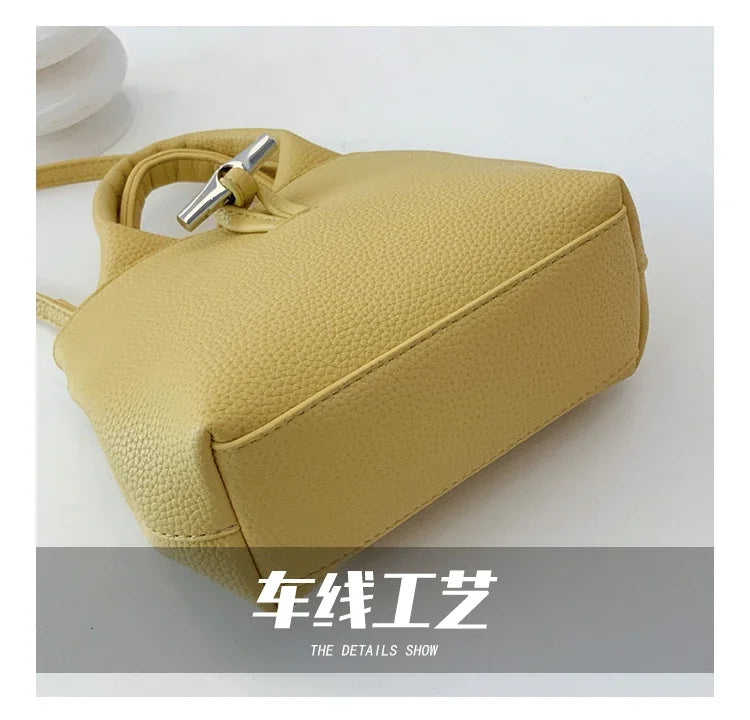 VaultHaus designer women's leather shoulder bag in light beige with textured finish and silver buckle detail