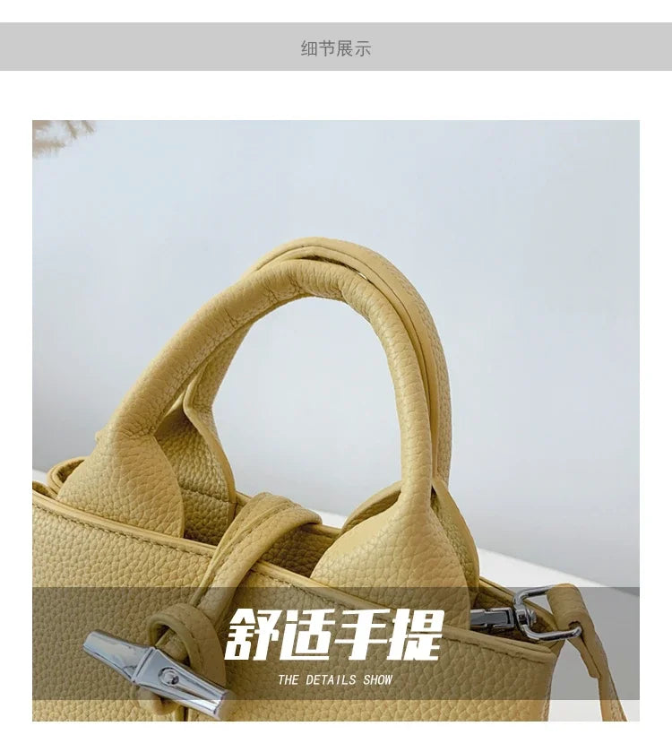 Close-up of VaultHaus designer women's leather shoulder bag handle in beige textured leather