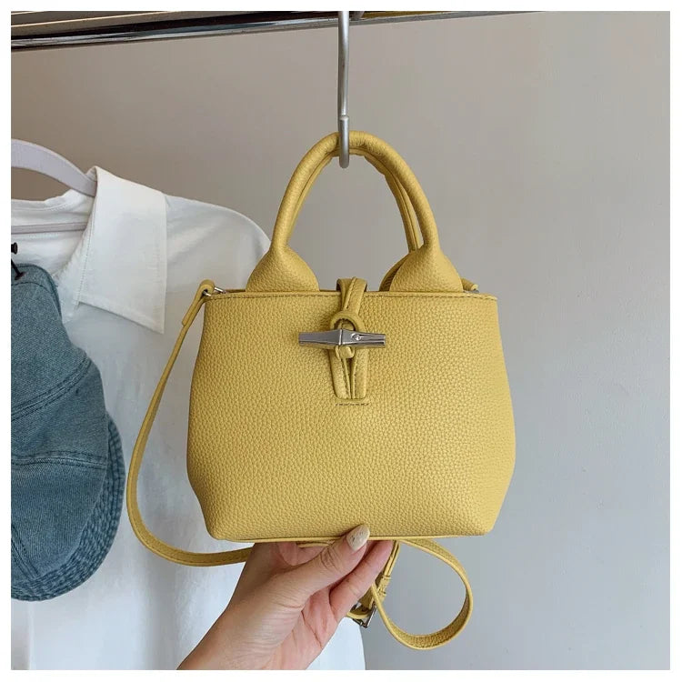VaultHaus designer women's leather shoulder bag in yellow with textured finish and silver clasp