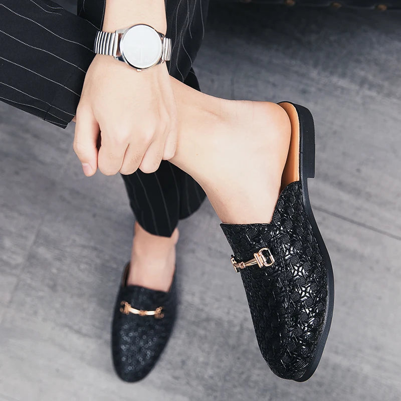 VaultHaus black fashion mules for men with textured design and gold buckle detail on gray floor
