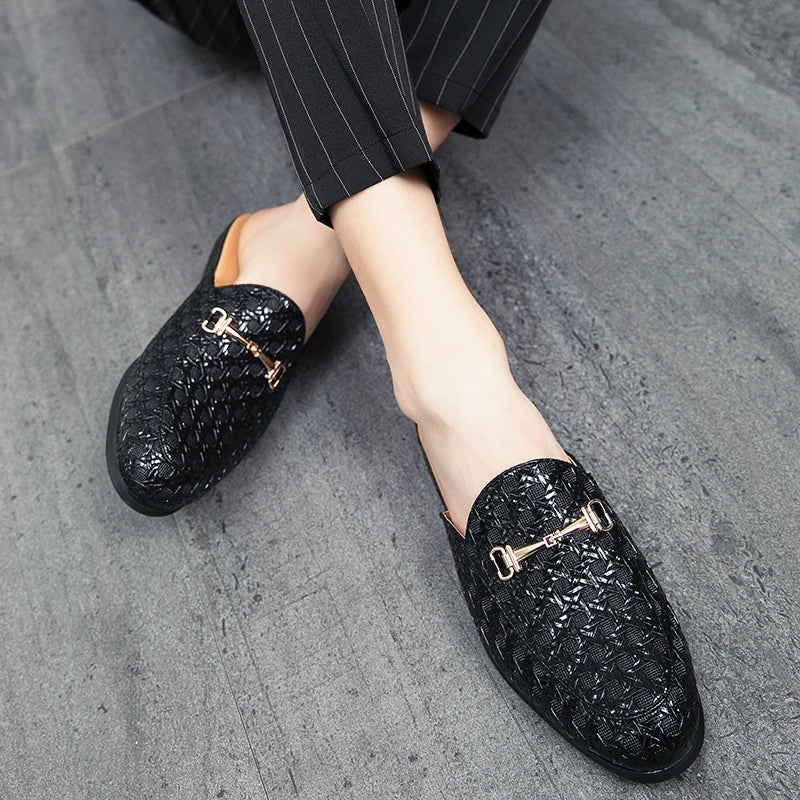 VaultHaus black woven leather fashion mules for men with gold buckle detail worn with pinstripe pants