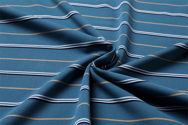 Close-up of soft fabric featuring blue and yellow stripes for a business casual short sleeve polo