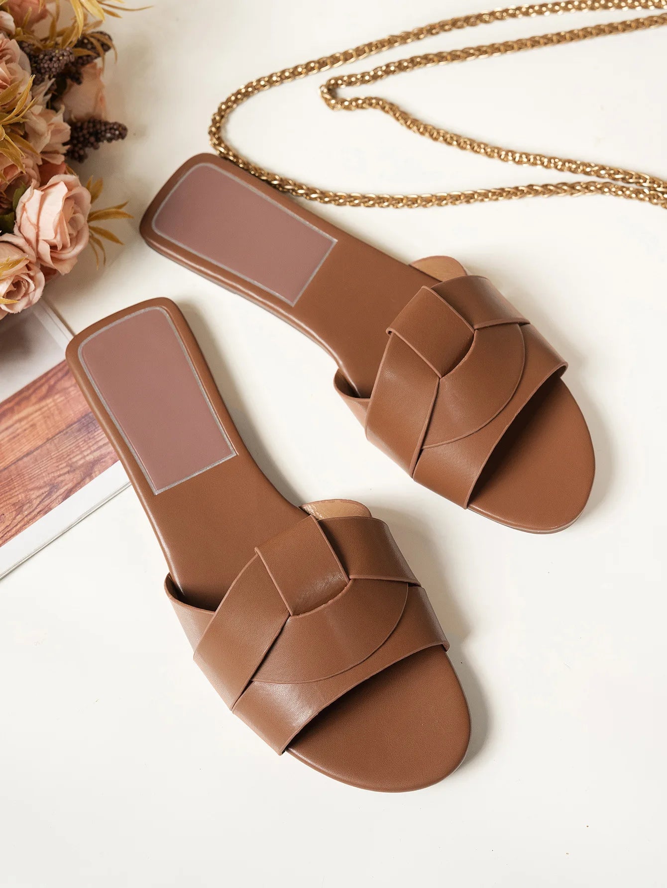 Stylish brown flat designer sandals 2025 with a chic cross strap design for casual wear