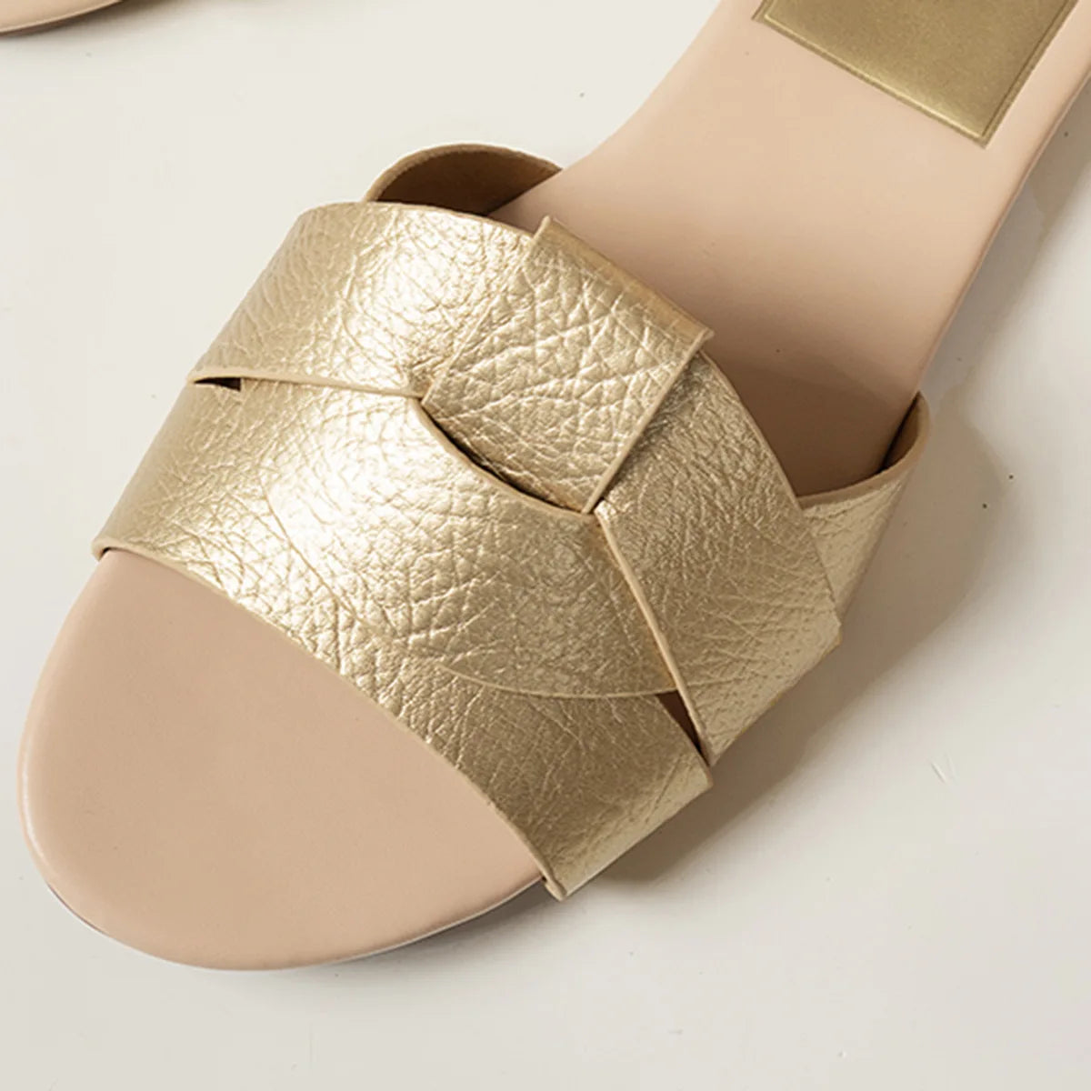 Stylish gold flat designer sandals 2025 with chic woven strap design for summer outings