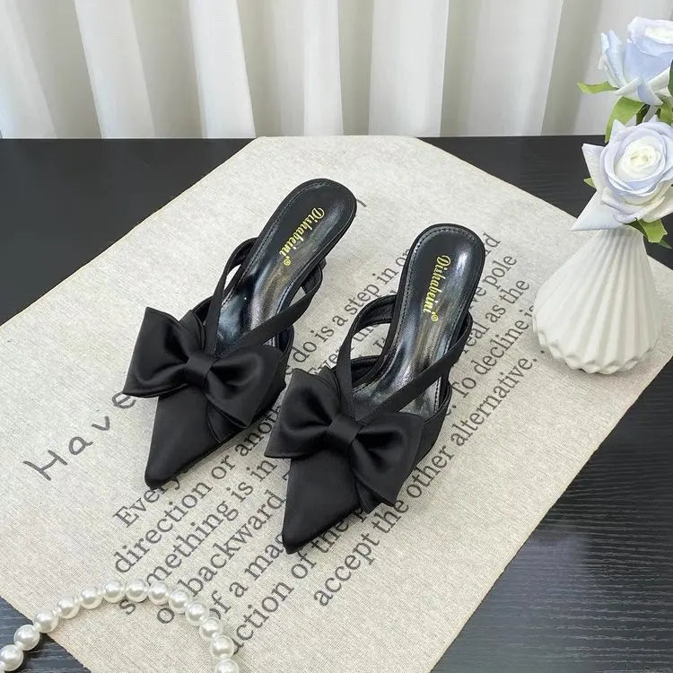 Chic black French style pink slippers with elegant bow detail for stylish comfort