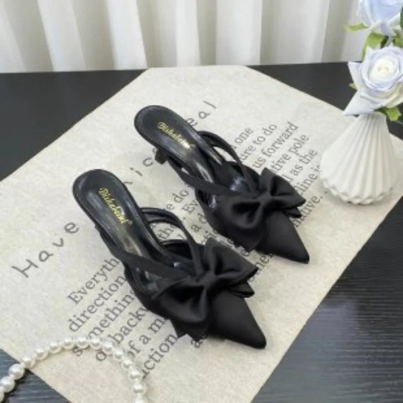 Elegant black slippers with bow detail, perfect pairing for French style pink slippers