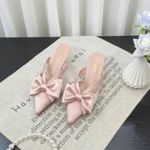 Stylish French style pink slippers with bow detail, perfect for casual or elegant occasions