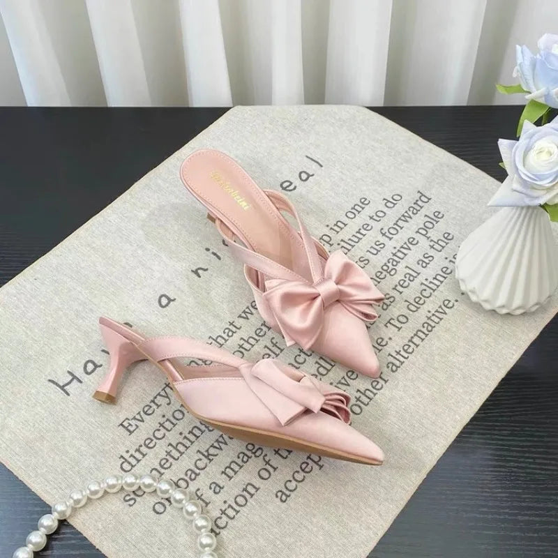 Stylish French style pink slippers with a bow and a small heel for elegant comfort