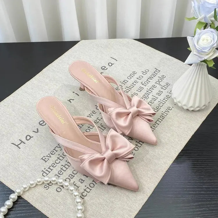Elegant French style pink slippers with bow detail, perfect for stylish comfort at home