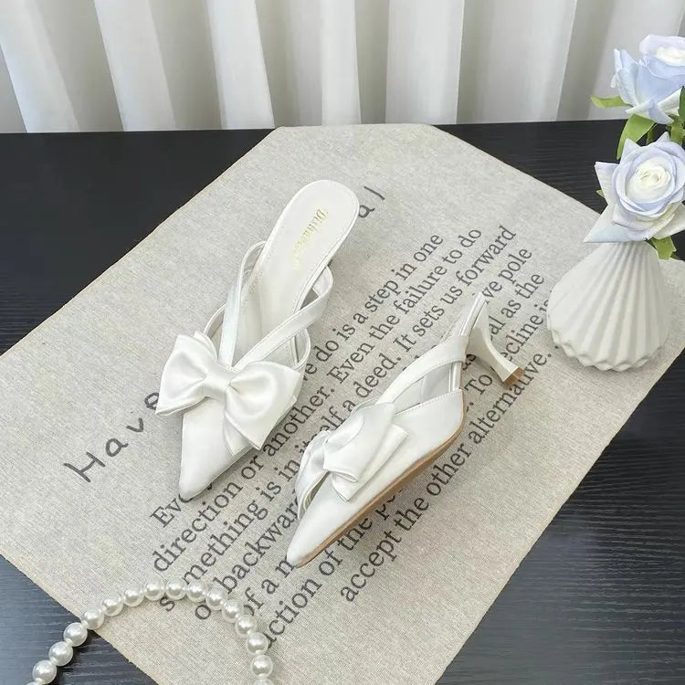 Elegant French style pink slippers with bow detail, perfect for chic home comfort