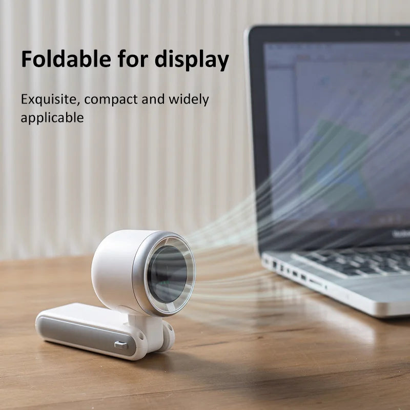 VaultHaus handheld turbo fan foldable compact design blowing air near laptop on wooden table
