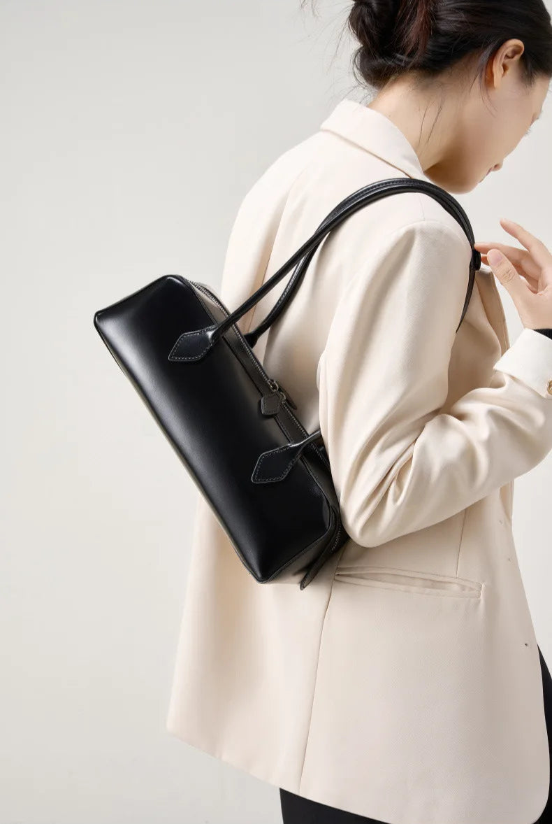 Stylish black ladies baguette shoulder bag worn casually for elegant everyday use