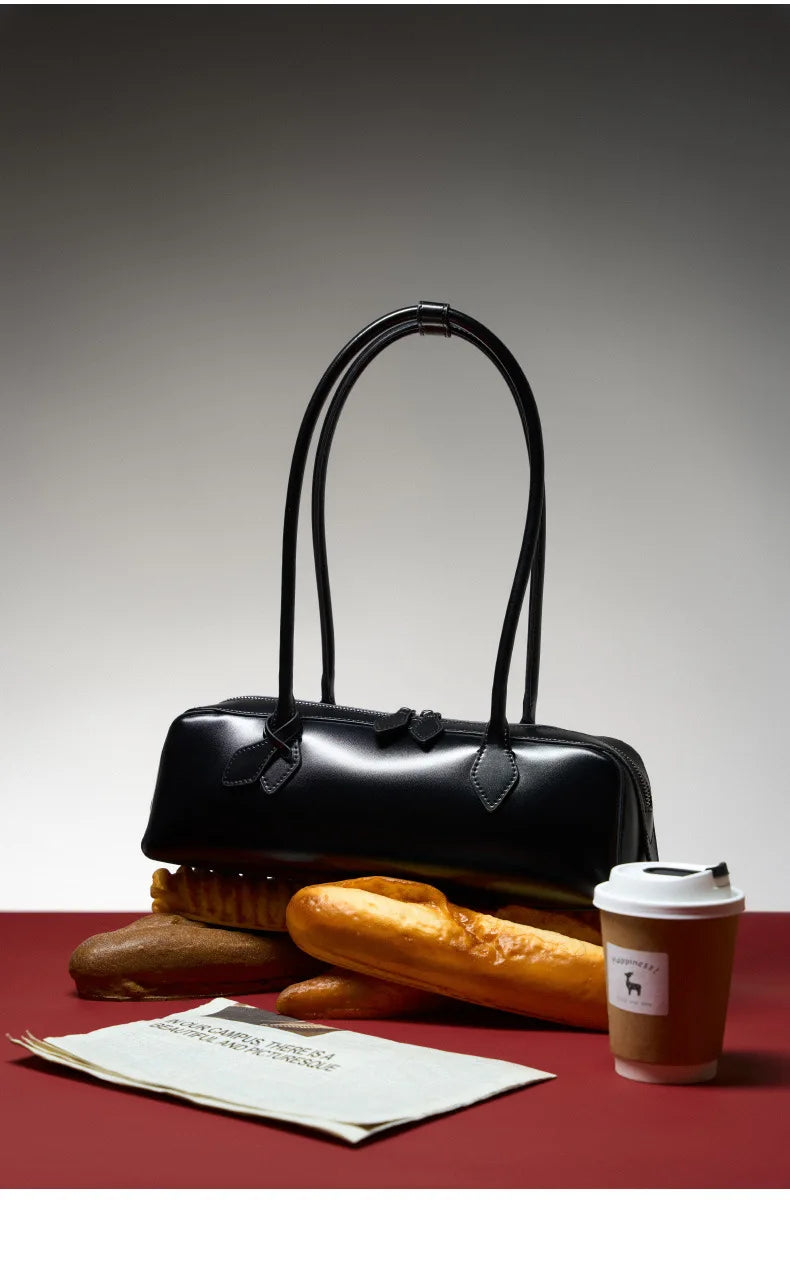 Elegant black ladies baguette shoulder bag styled with fresh bread and coffee for a chic look