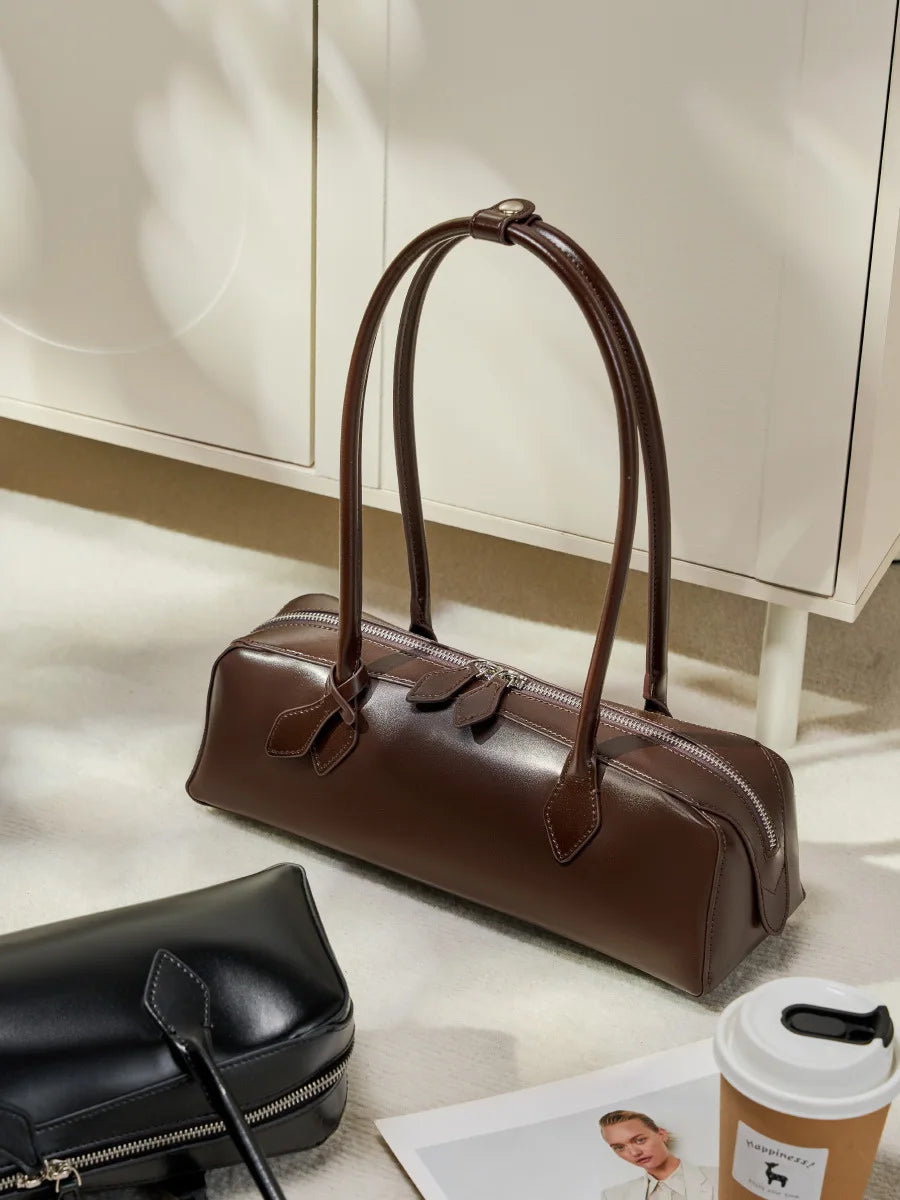 Stylish brown ladies baguette shoulder bag with elegant handles and sleek design