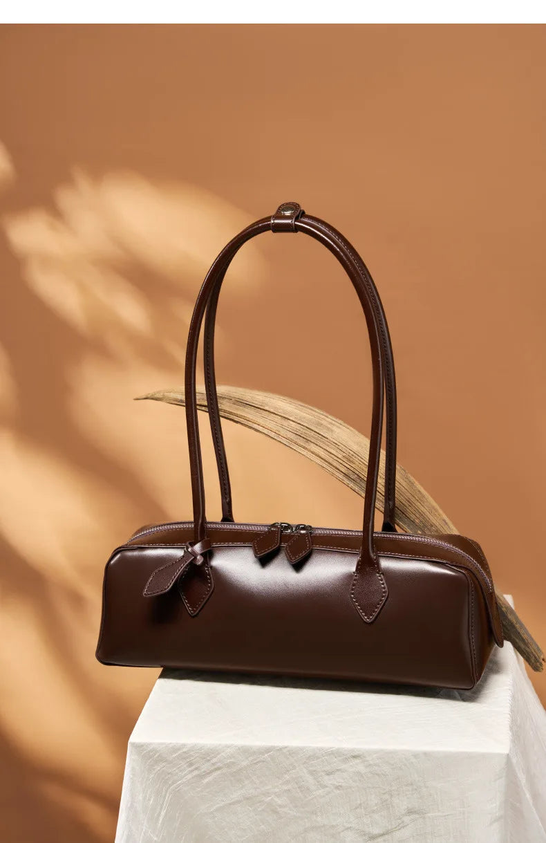Stylish brown ladies baguette shoulder bag with elegant design and dual handles