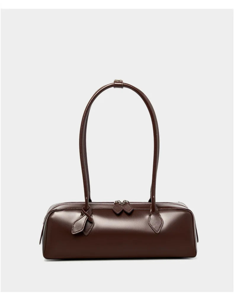 Stylish brown ladies baguette shoulder bag with elegant design and curved handle