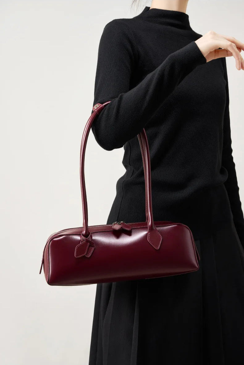 Burgundy ladies baguette shoulder bag with stylish design, perfect for everyday use and chic outfits