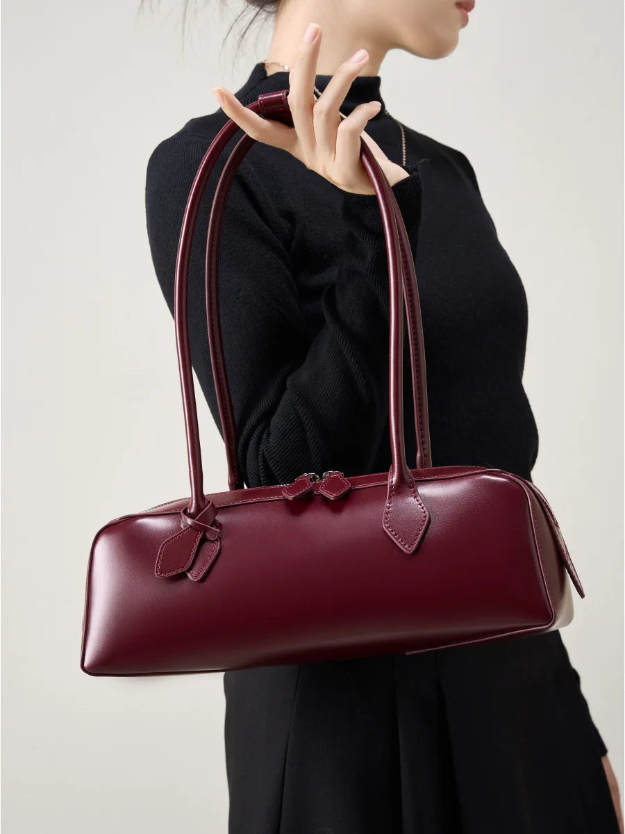 Stylish burgundy ladies baguette shoulder bag with elegant handles for trendy outfits