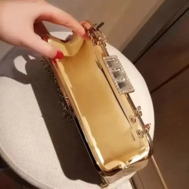Ladies luxury evening purse with a sleek gold finish and ornate clasp for special occasions
