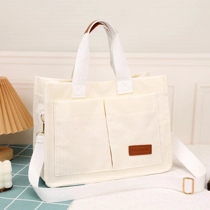 VaultHaus large capacity canvas handbag in cream color with multiple pockets and adjustable strap