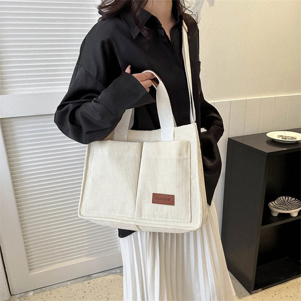 Stylish large capacity canvas handbag in cream color, perfect for daily use and casual outings