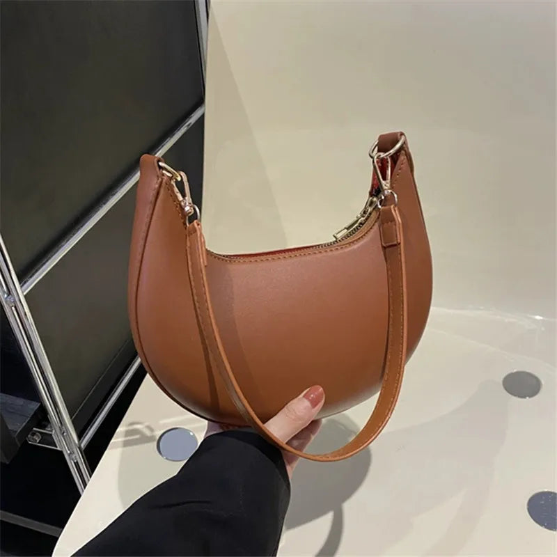 Stylish luxury moon-shaped handbag in brown, perfect for casual and formal outings