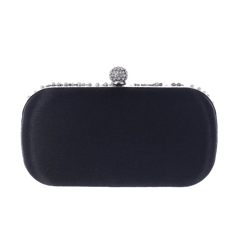 Black pearl embellished evening clutch bag with rounded edges and jeweled clasp by VaultHaus